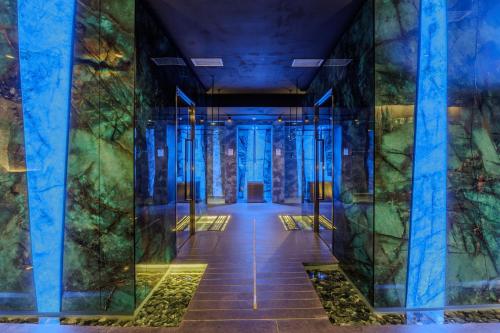 a hallway of a building with blue lights at Deville & Spa in Costermano sul Garda