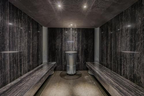 a room with wooden walls and a toilet in it at Deville & Spa in Costermano sul Garda