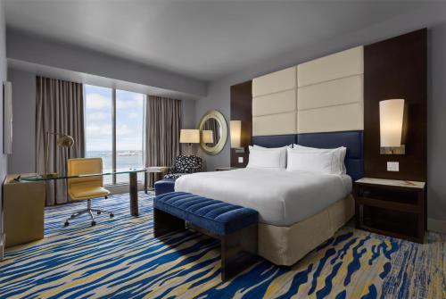 a hotel room with a bed and a desk at Hilton Panama in Panama City