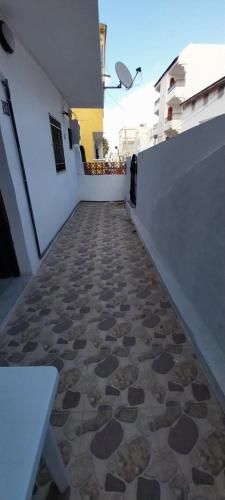 a walkway with a tiled floor next to a building at Studio SARAH in Tabarka
