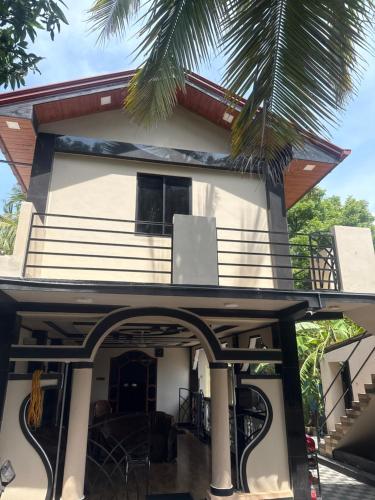 a house with a balcony with a speaker on it at Easy-inn in Point Pedro