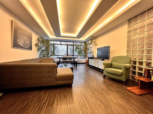 a large living room with a couch and a television at LXRY Apt Bestekar Avenue at the heart of Ankara in Ankara