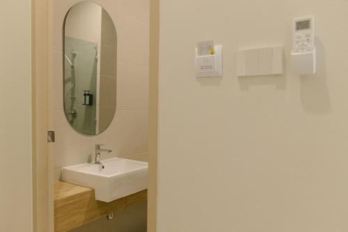 a bathroom with a sink and a mirror at My Hotel Kanchanaburi in Ban Chuk Kum
