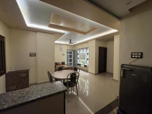 a kitchen and dining room with a table and chairs at Hridayam Kashi Homestay- Maldahiya in Varanasi