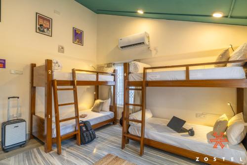 a room with three bunk beds in a hostel at Zostel Chennai, Anna Nagar in Chennai