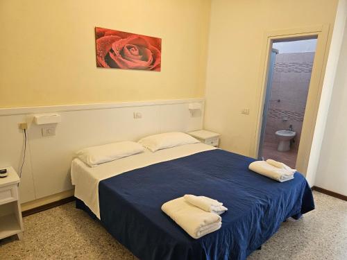 a bedroom with a bed with two towels on it at Hotel Riviera Nuova Gestione in Cattolica