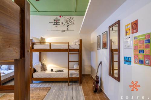 a room with three bunk beds in a room at Zostel Chennai, Anna Nagar in Chennai