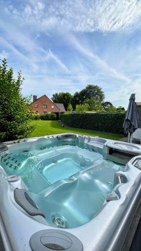 a jacuzzi tub in the backyard of a house at Bruggeske aan't bos in Mol
