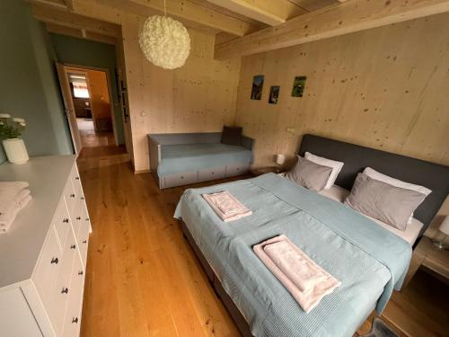 a bedroom with a large bed and a desk at Chalet Rokytnice in Rokytnice nad Jizerou