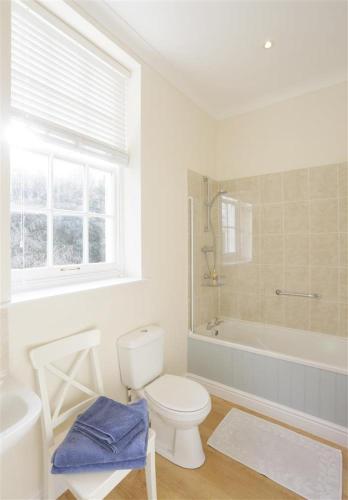 a bathroom with a toilet and a tub and a sink at Garden View in Parham