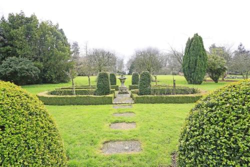a garden with bushes and a path in the grass at Garden View in Parham