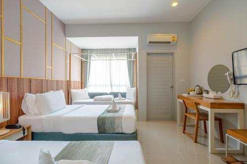 Postel nebo postele na pokoji v ubytování Hug Nimman Hotel