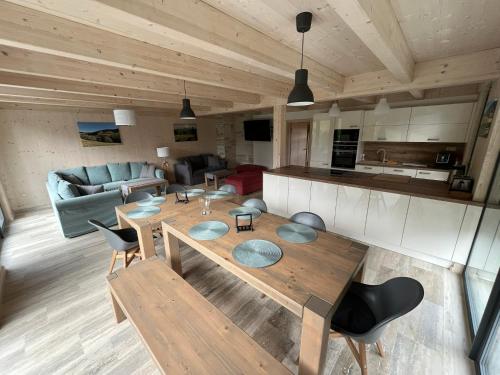 a living room with a table and a couch at Chalet Rokytnice in Rokytnice nad Jizerou