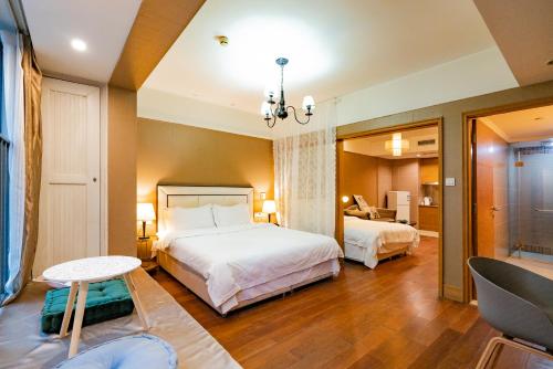 a hotel room with two beds and a chair at Chongqing Forest Design B&B in Chongqing