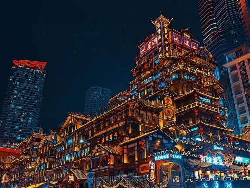 a tall building with a clock tower on top of it at Chongqing Forest Design B&B in Chongqing