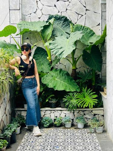 a woman standing in front of a bunch of plants at Sapa Villa Florence in Sa Pa