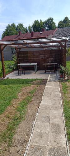 a picnic shelter with two benches in a park at Ubytovací zařízení Orlíček Černíkovice čp 145 in Černíkovice