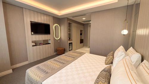 a bedroom with a large bed and a tv at Saygın Hotel Beşiktaş in Istanbul