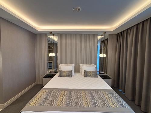 a bedroom with a bed with two pillows at Saygın Hotel Beşiktaş in Istanbul