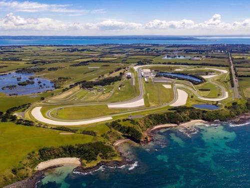an aerial view of a golf course next to the ocean at Tropicana Motor Inn in Cowes