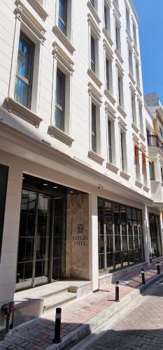 a large white building with windows on a street at Saygın Hotel Beşiktaş in Istanbul
