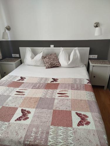 a bedroom with a bed with a quilt on it at Casa Mario in Sibiu