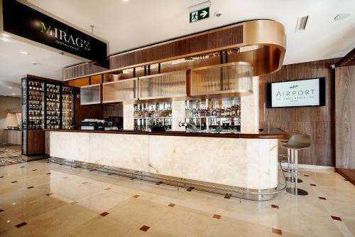 a bar in a restaurant with a counter with alcohol at Airport Hotel Okęcie in Warsaw