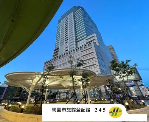 a large building in front of a city at XinsheHotel - Chungli in Zhongli