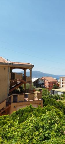 a building with a gazebo on the side of a city at Apartmani Relax D in Tivat