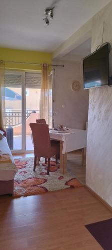 a living room with a table and a couch at Apartmani Relax D in Tivat