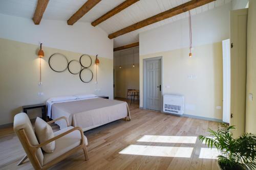 a bedroom with a bed and two rings on the wall at Vento Forte - eco dimore nel borgo in Civita