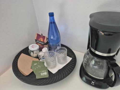 a black plate with a coffee maker and a bottle at Résidence Souverain 94 in Brussels