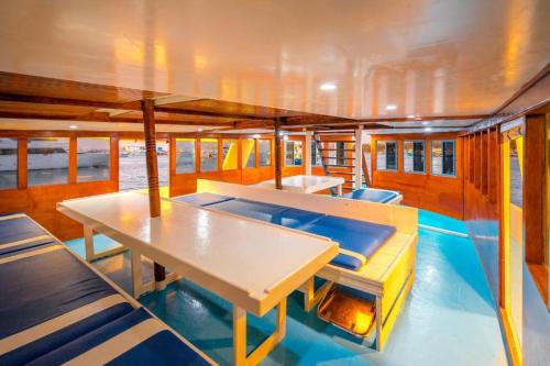 a boat with a table and chairs on it at MV Aisha Shafari Boat in Gulhi