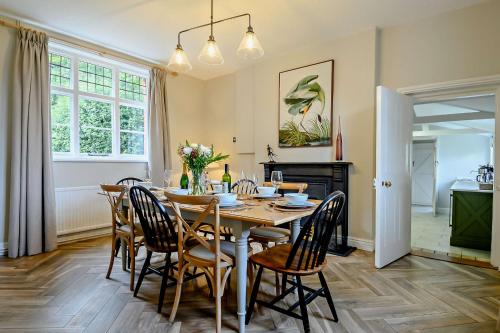 a dining room with a table and chairs at Gardeners Cottage - Nowton Park in Bury Saint Edmunds