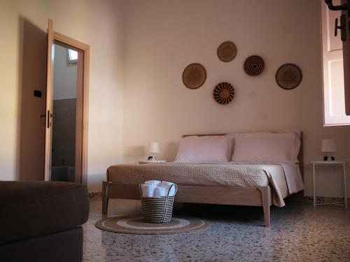 a bedroom with a bed and plates on the wall at Le Panare Home in Spongano
