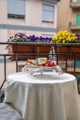 a white table with a plate of food on it at B&B Accademia in Verona
