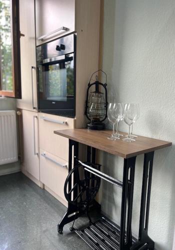 two wine glasses on a table in a kitchen at Georges Apartment in Tbilisi City