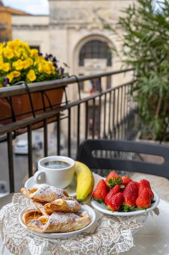 a table with two plates of food and strawberries at B&B Accademia in Verona