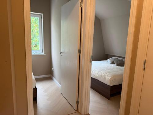 a bedroom with a door leading to a bed at Naest - Authentic Escapes Grand House in Nijmegen