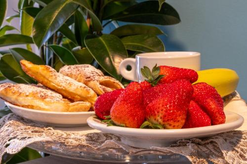 a plate of strawberries and pastries on a table at B&B Accademia in Verona