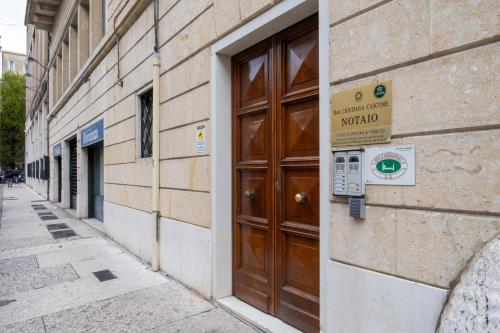 a wooden door on a building with a sign on it at B&B Accademia in Verona