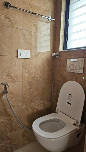 a bathroom with a toilet and a shower at Yangla Home in Kathmandu