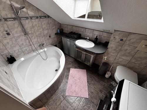 a bathroom with a large tub and a sink at AlpenRide Ski & Bike Urlaub in Fliess