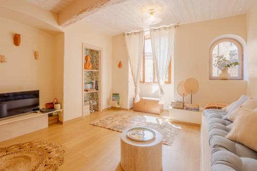 a living room with a couch and a table at Les Fontaines Saint-Paul-de-Vence Free Parking in Saint-Paul-de-Vence