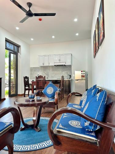 a living room with a couch and a table at Hoa Cau HoiAn in Cam Thanh