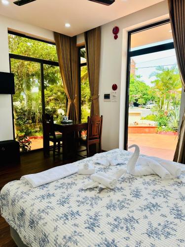 a bedroom with a bed with a view of a patio at Hoa Cau HoiAn in Cam Thanh