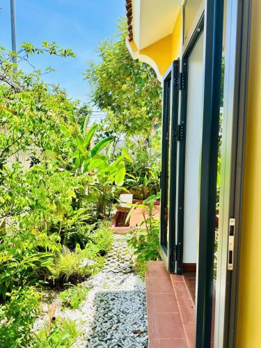 an open door of a house with a garden at Hoa Cau HoiAn in Cam Thanh