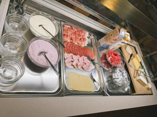 a tray of food with meat and other food items at Pension Wiesenhof in Campo di Trens