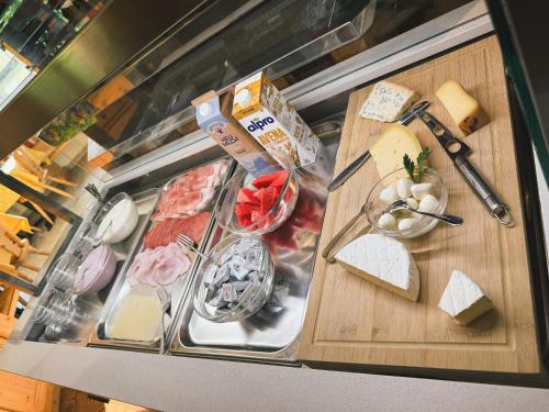 a display case with different types of cheese and meats at Pension Wiesenhof in Campo di Trens