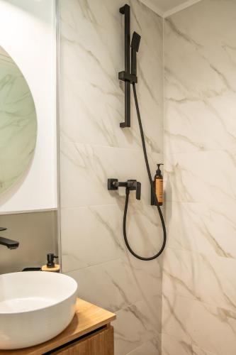 a bathroom with a shower and a sink at Volotel SkyWay in Cluj-Napoca